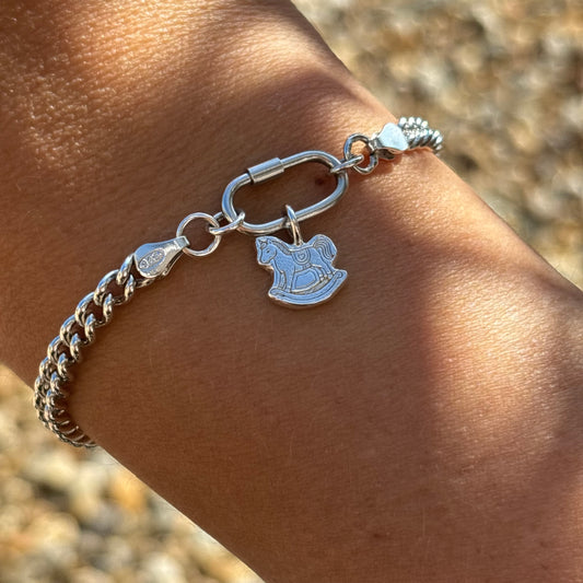 Silver curb chain bracelet with silver rocking horse charm