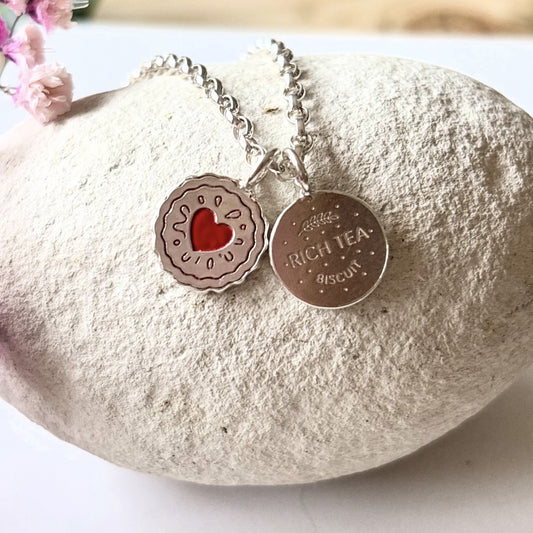 Silver necklace with a silver jammy dodger charm and a silver rich tea biscuit charm