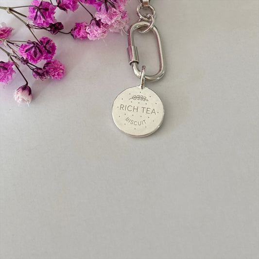 Silver Rich Tea Biscuit Charm surrounded by flowers 