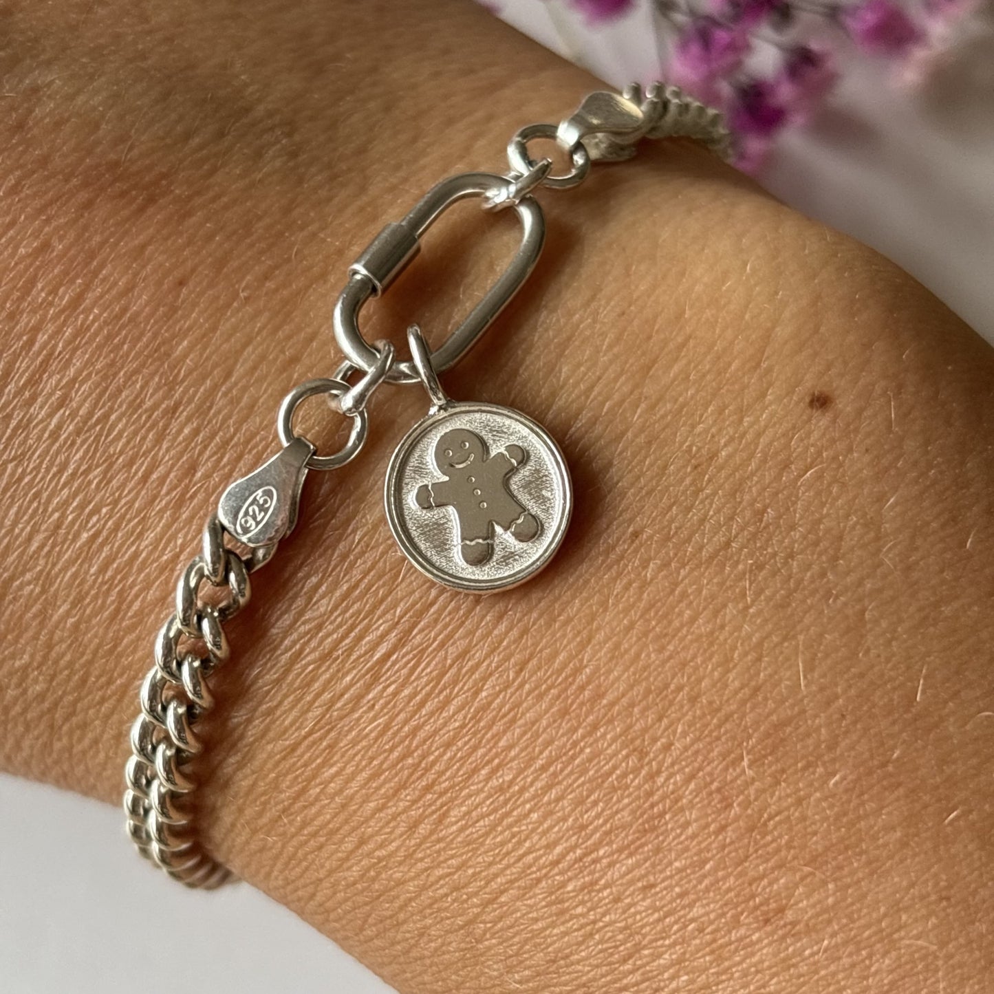 Handmade solid silver gingerbread man charm bracelet on wrist