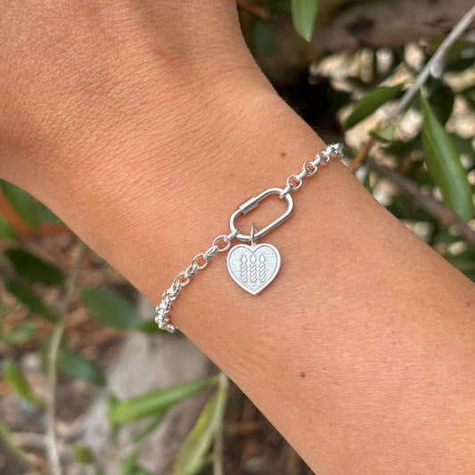 Sterling silver bracelet with a silver heart charm with three silver candles 