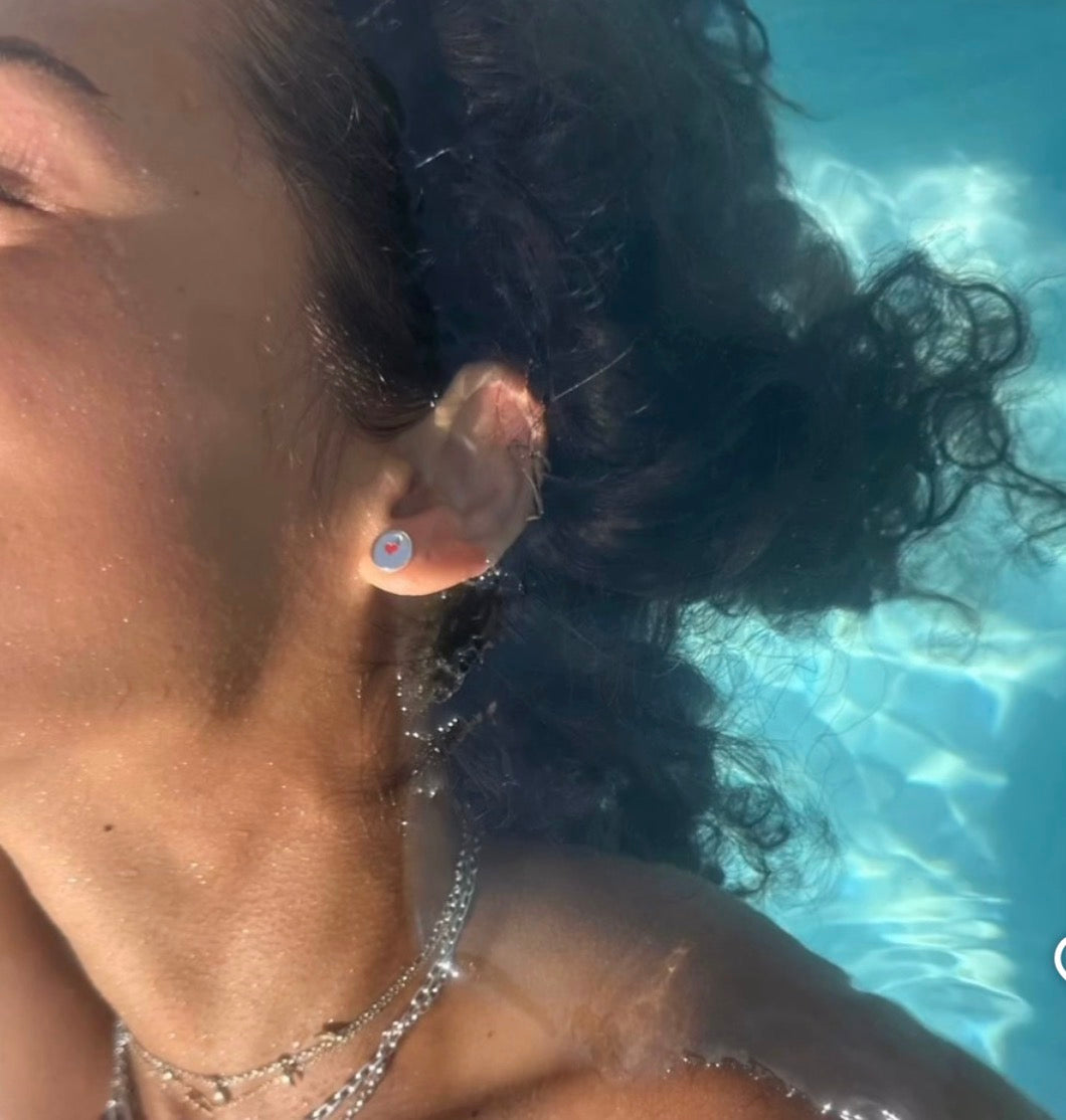 Lady wearing silver studs with red heart 