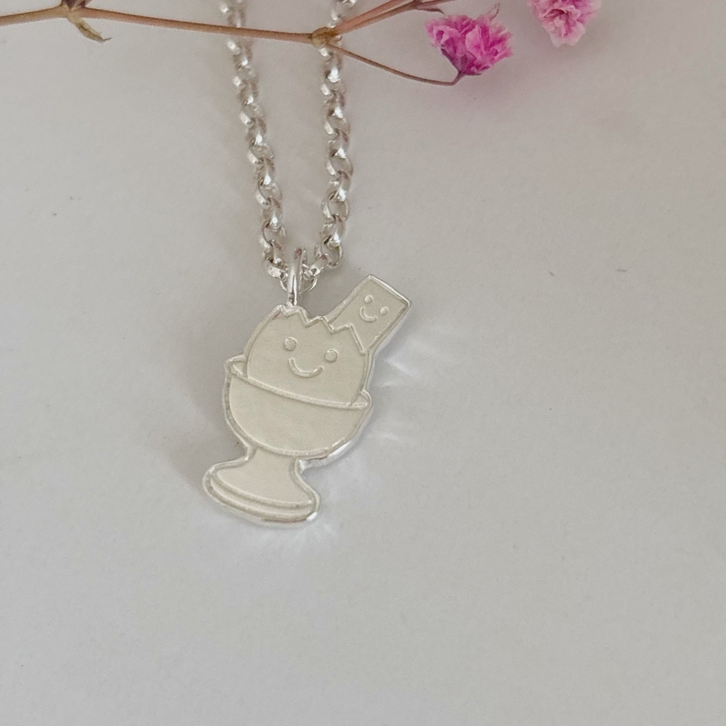 Silver Happy Dippy Egg & Soldier necklace with engraved faces.