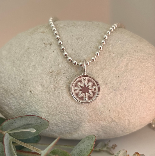 Solid silver compass pendant close-up