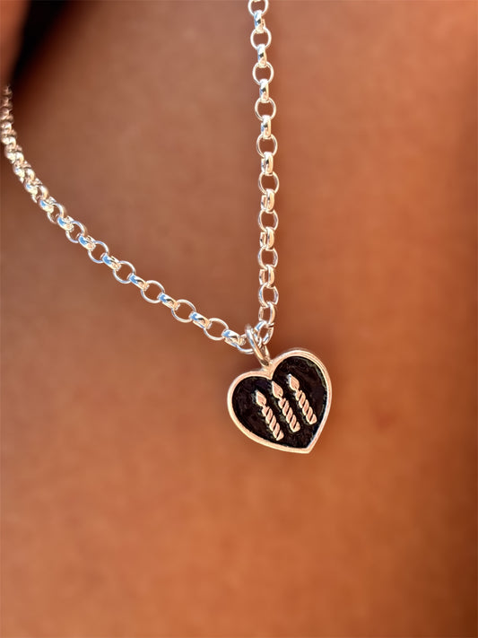 Silver charm necklace with three silver candles and black enamelled background 