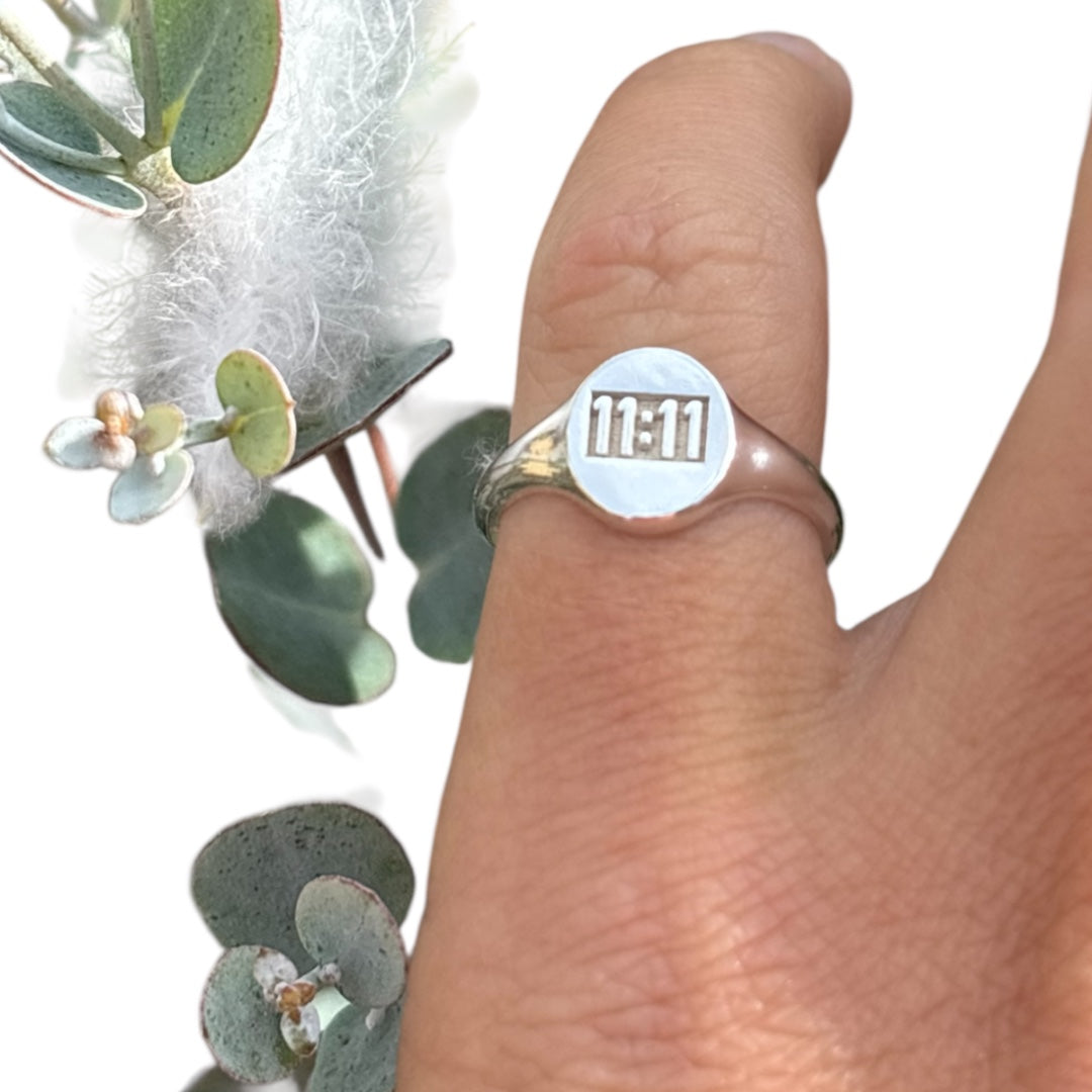 11:11 engraved on a sterling silver oval signet ring