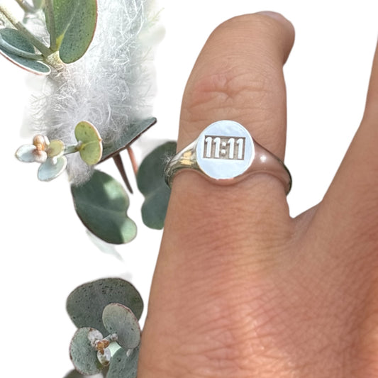 11:11 engraved on a sterling silver oval signet ring