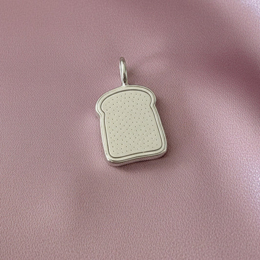 Toast-shaped pendant on a pink fabric background