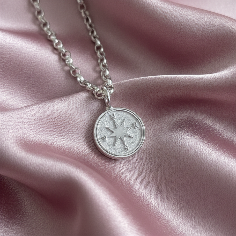 Silver compass charm necklace on dusky link satin