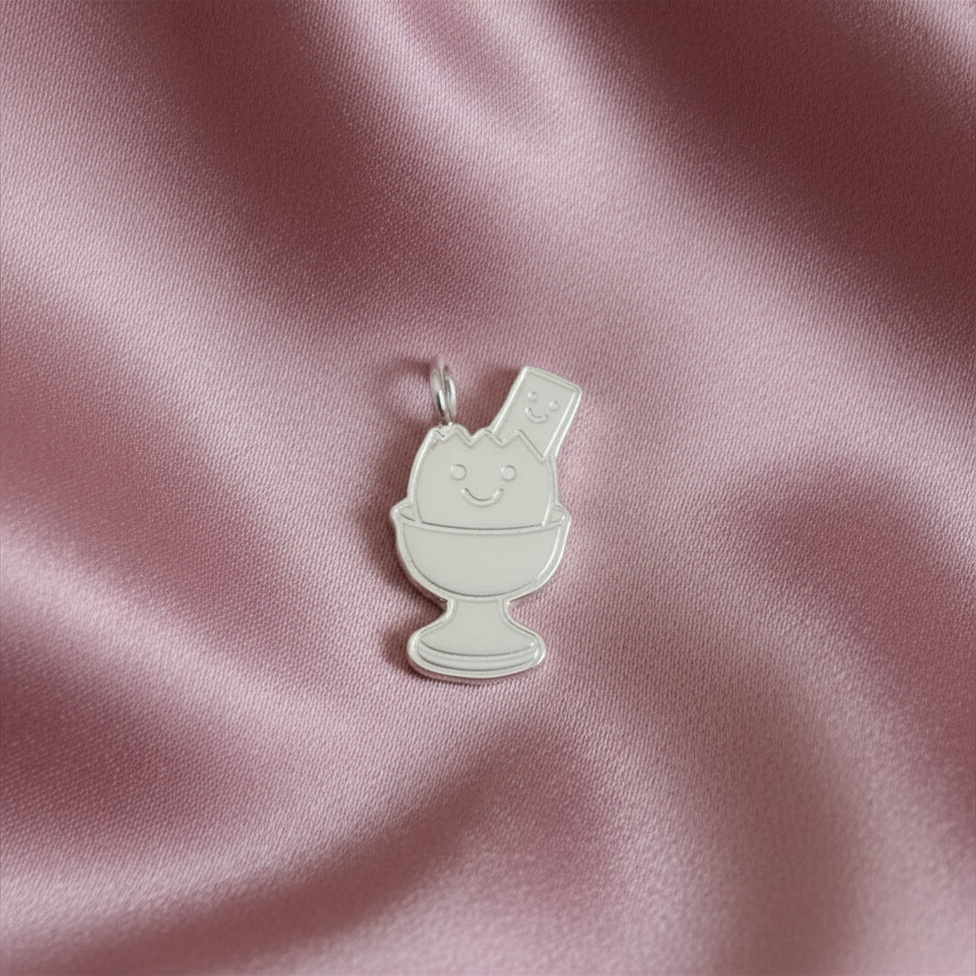 Silver Egg and soldier charm with smiley faces on dusky link satin